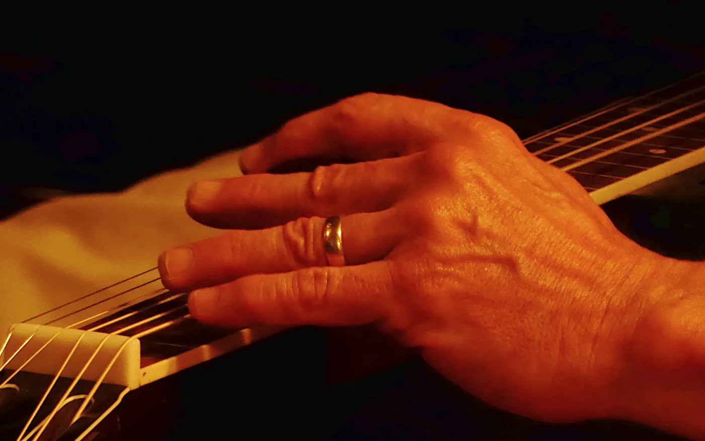 A flamenco guitarist playing on a small stage